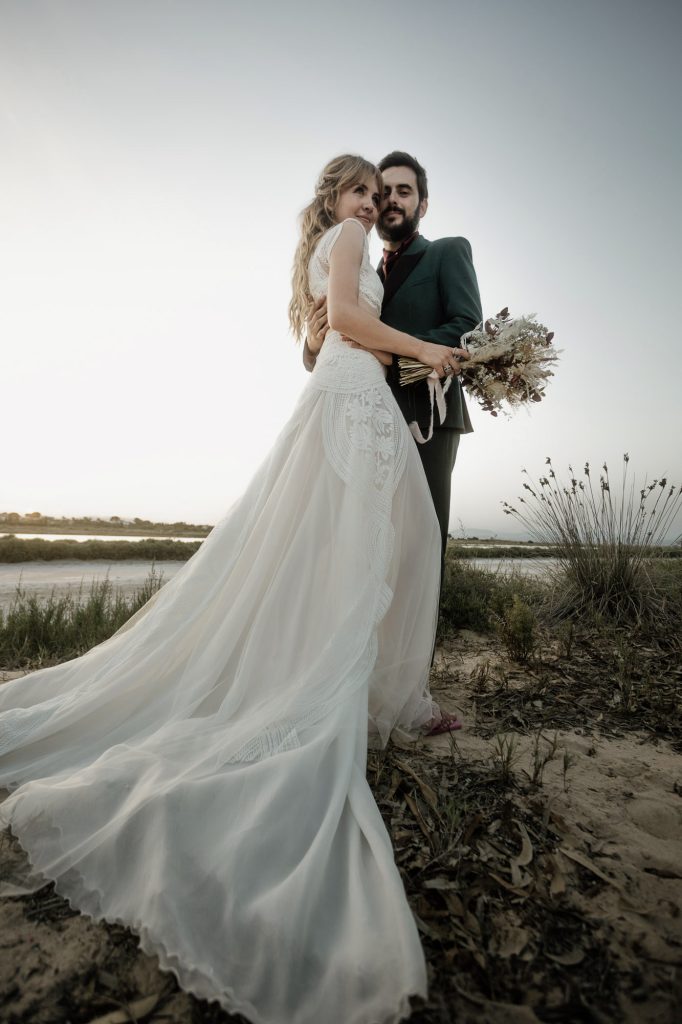 Newlywed couple embraced in a beautiful wedding sunset. Pareja de recién casados abrazados en un hermoso atardecer de boda.